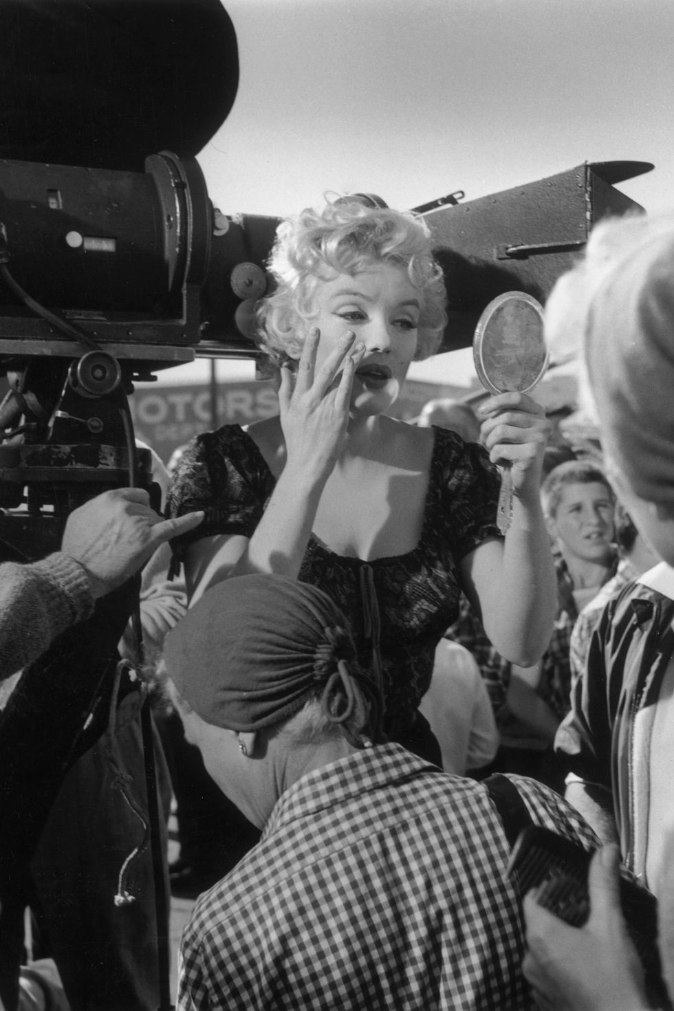 <p>Fixing her makeup on the set of <em>Bus Stop</em> in 1956</p>