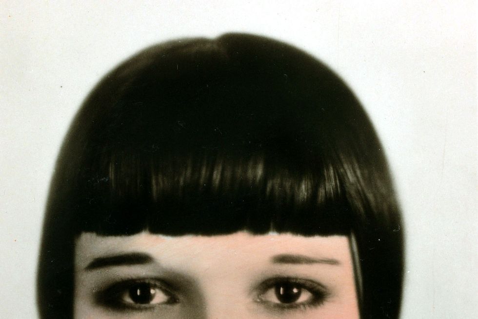 <p>The total opposite of the era's fluffier looks, <a href="http://www.goodhousekeeping.com/beauty/hair/news/g3297/blunt-bangs-trend/" target="_blank">blunt bangs</a> framed the face (and thin '20s brows) in the most literal way possible.</p>
