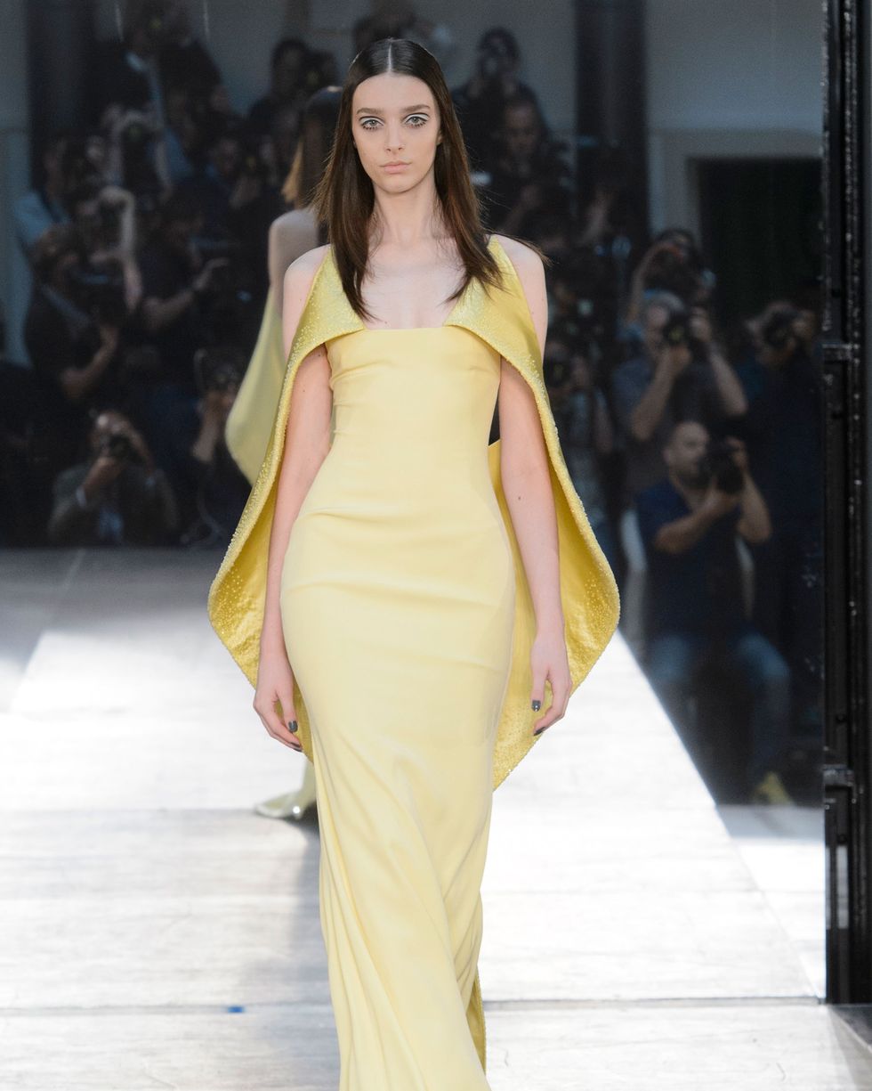 Fashion show, Yellow, Hairstyle, Shoulder, Runway, Fashion model, Joint, Style, Formal wear, Beauty, 