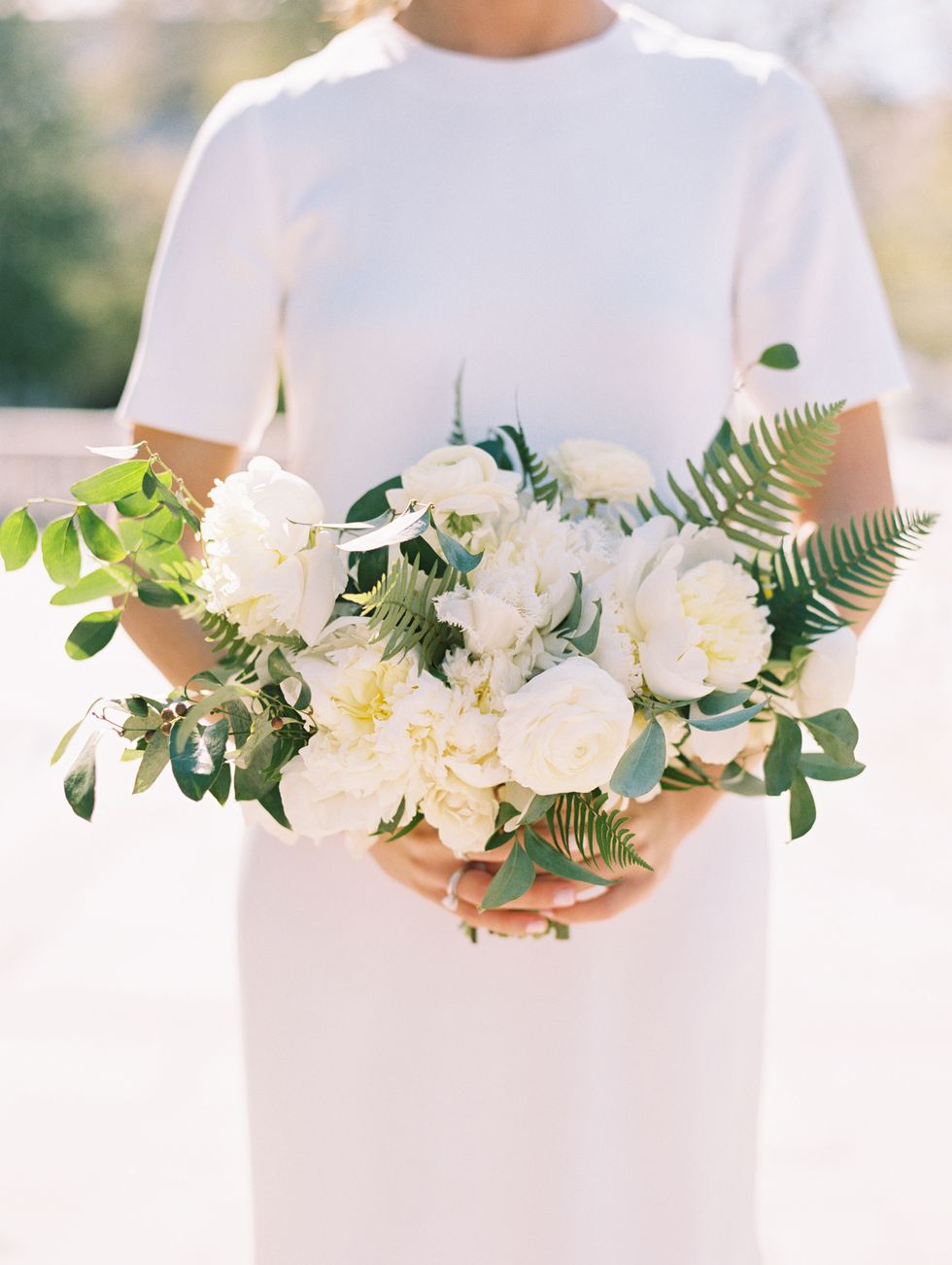 <p>"From the beginning, I knew I wanted to go with white flowers," said the bride. "We had a mix of different flowers, but my favorites were the fringe tulips." <a href="http://sweetrootvillage.com/" target="_blank" tabindex="-1">Sweet Root Village</a><u> </u>created her clean, white bouquet, which also included smilax vines, garden roses, spray roses, ranunculus, peonies, and a mix of greenery.</p>