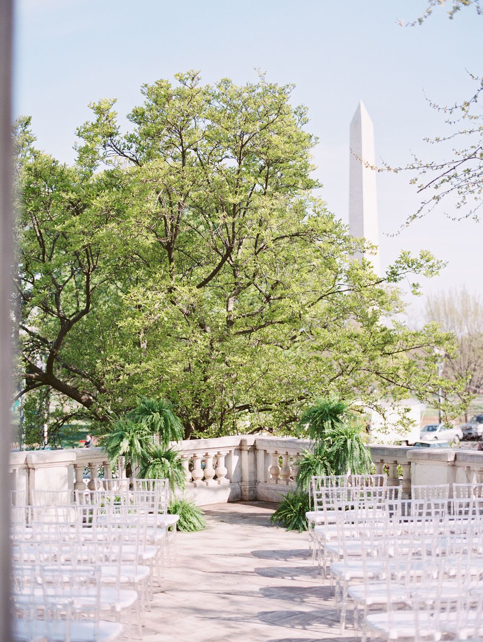 <p>The ceremony took place on the portico of DAR with the Washington Monument in the background and was anchored by a large tree for décor. "After choosing a location like DAR, it was almost like it didn't matter what we put there because it was already so beautiful," says Arielle.</p>