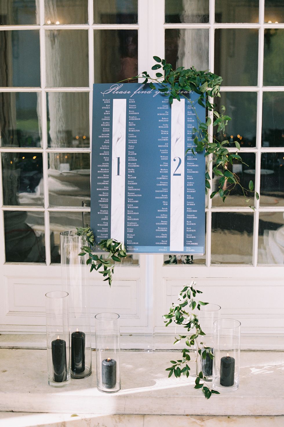 <p><a href="http://gritandgraceinc.com/#story" target="_blank" tabindex="-1">Grit & Grace</a> created the blackboard seating chart that sat atop a clear easel draped with greenery and surrounded by black candles. "Having the seating chart was a last-minute decision, and it turned out to be a really cool addition to the wedding," said Arielle.</p>