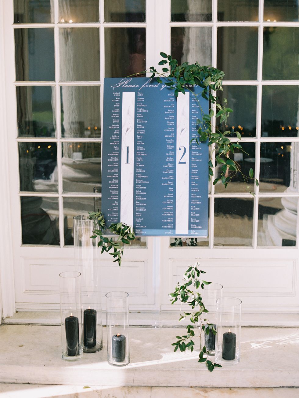 <p><a href="http://gritandgraceinc.com/#story" target="_blank" tabindex="-1">Grit & Grace</a> created the blackboard seating chart that sat atop a clear easel draped with greenery and surrounded by black candles. "Having the seating chart was a last-minute decision, and it turned out to be a really cool addition to the wedding," said Arielle.</p>