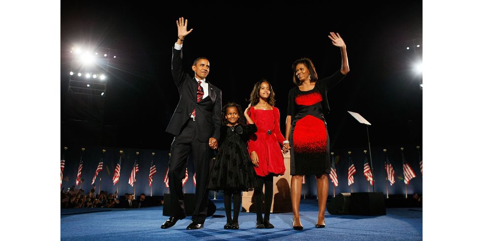 CHICAGO - NOVEMBER 04:  U.S. President elect Barack Obama stands on stage along with his wife Michelle and daughters Malia (red dress) and Sasha  (black dress) during an election night gathering in Grant Park on November 4, 2008 in Chicago, Illinois. Obama defeated Republican nominee Sen. John McCain (R-AZ) by a wide margin in the election to become the first African-American U.S. President elect.  (Photo by Joe Raedle/Getty Images)