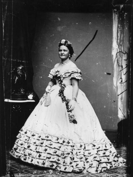 <p>A floral headpiece and sash picks up the embroidered floral accents in the dress Mary Todd Lincoln wore for her husband's inauguration. She famously loved to shop, racking up thousands of dollars in bills for clothes and decorations for the White House (which <a href="http://www.mrlincolnandnewyork.org/mr-lincolns-visits/mrs-lincolns-shopping/" target="_blank" data-tracking-id="recirc-text-link">reportedly enraged</a> the more practical President Lincoln).&nbsp;</p>