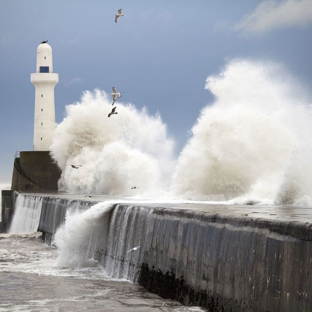 Storm waves hitting lighthouse