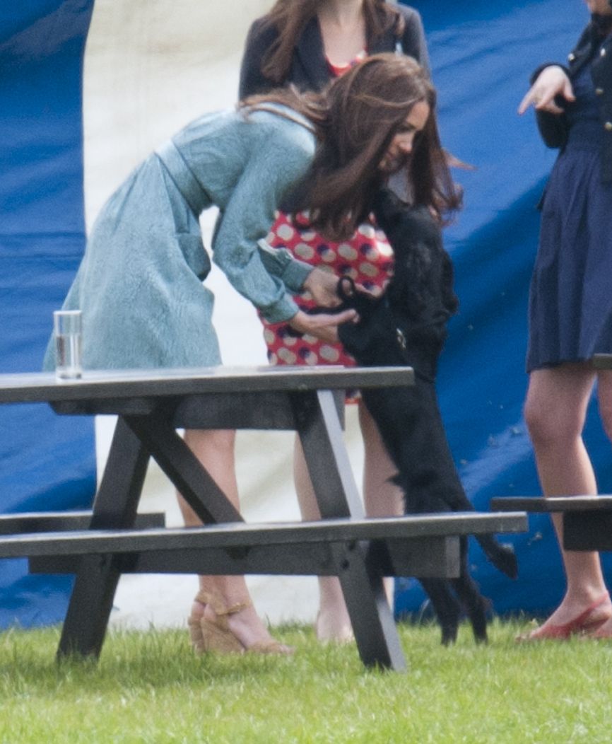<p>Bonding with her dog Lupo at the Audi Polo Challenge Charity Polo Match at Coworth Park Polo Club in Ascot,<span class="redactor-invisible-space" data-verified="redactor" data-redactor-tag="span" data-redactor-class="redactor-invisible-space"></span> England.</p>