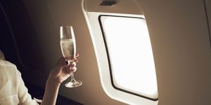 Woman drinking champagne on aeroplane