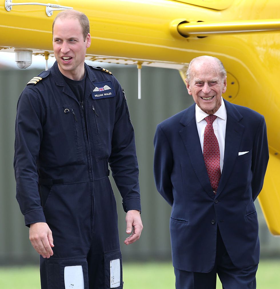 Prince Philip with his grandson Prince William during a visit to the East Anglian Air Ambulance Base, 2013