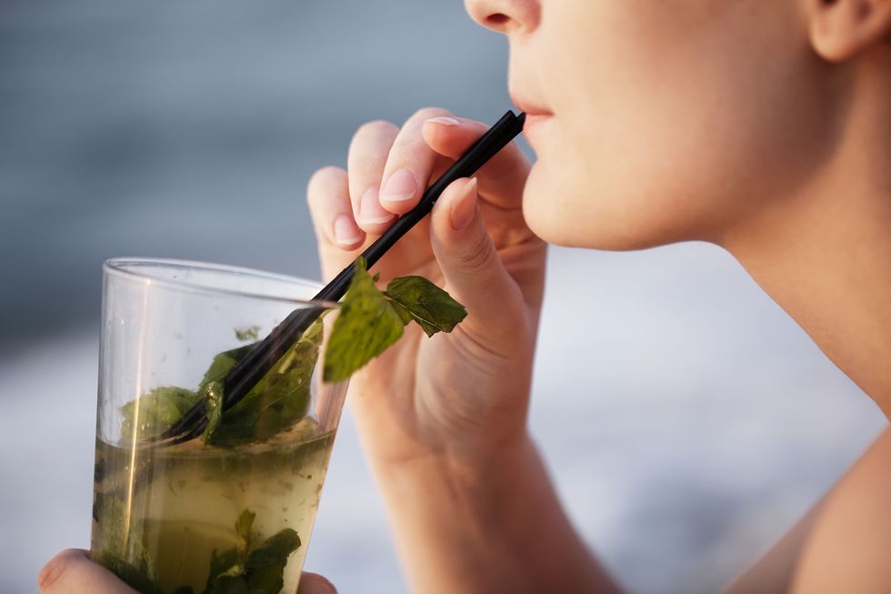 Woman drinking with a straw