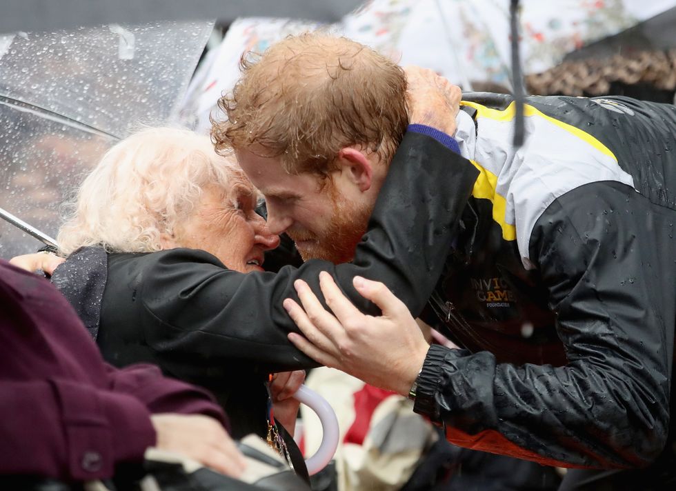 Prince Harry  Patron of the Invictus Games Foundation Prince Harry hugs 97 year old Daphne Dunne during a walkabout in the torrential rain ahead of a Sydney 2018 Invictus Games Launch Event at the Overseas Passenger Terminal on June 7, 2017 in Sydney, Australia. Prince Harry is on a two-day visit to Sydney for the launch of the Invictus Games Sydney 2018. The fourth Invictus Games will be held in Sydney from 20th to 27th October