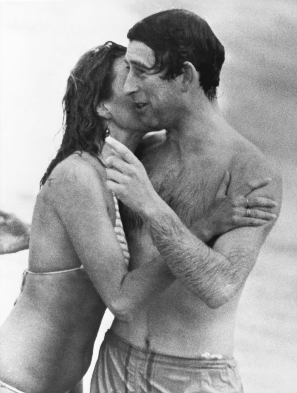 Prince Charles is kissed by Jane Priest, a model, as he emerges from the water at Cottesloe beach in Perth, during his 1979 tour of Australia.