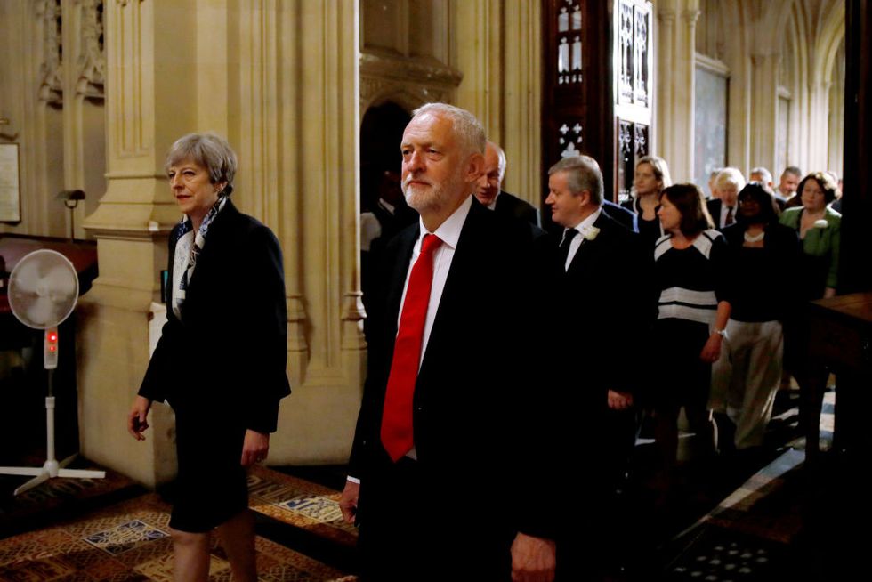 Theresa May and Jeremy Corbyn walk through the lobby of the Houses of Parliament at the Queen's Speech