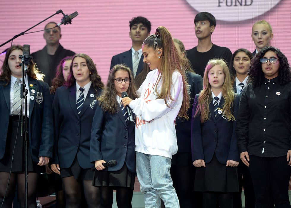 Ariana Grande on stage with Parrs Wood High School Choir at One Love Manchester concert