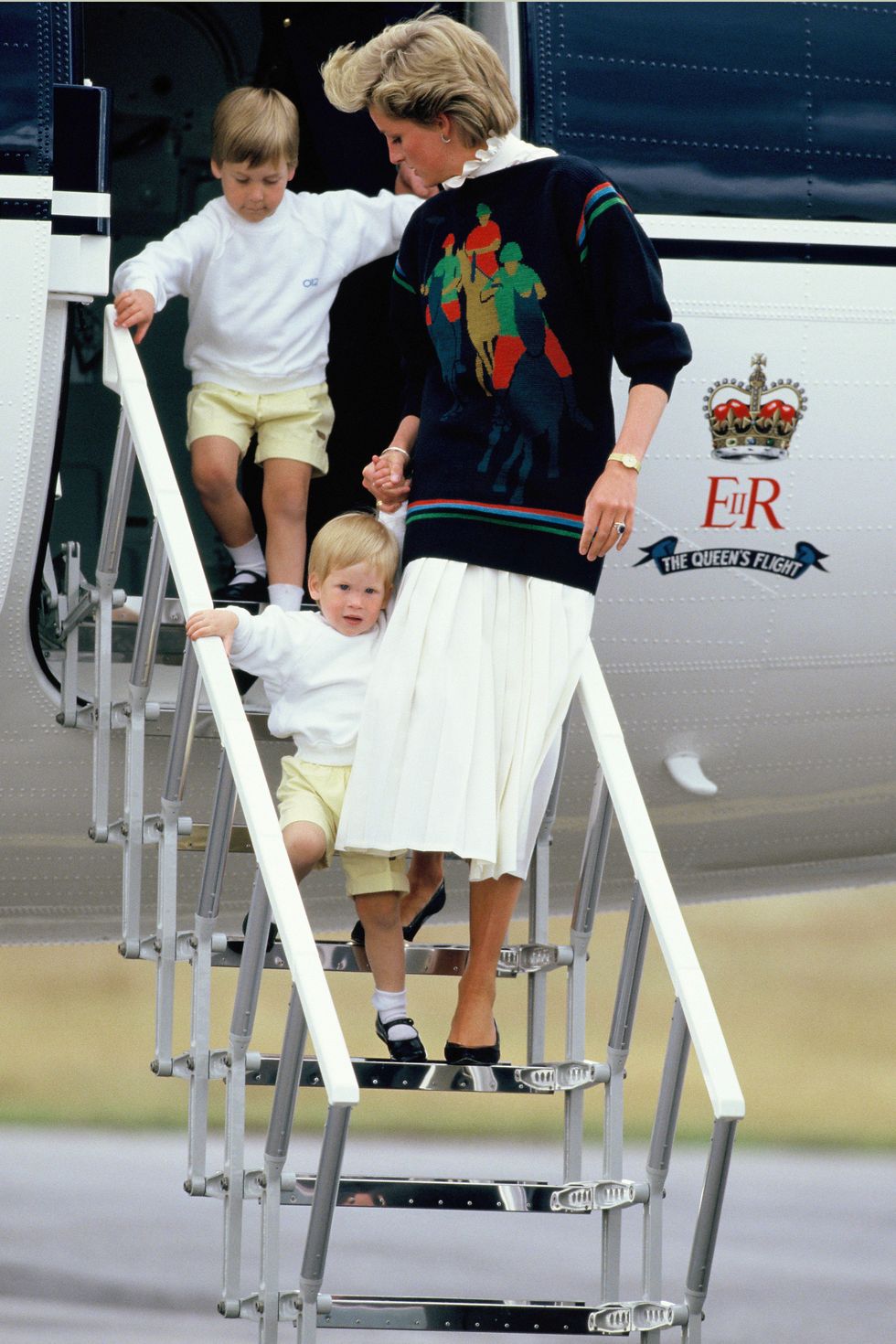 Prince William, Princess Diana and Prince Harry arrive at Aberdeen Airport for the start of their holidays in Scotland on August 15, 1986 in Aberdeen, Scotland