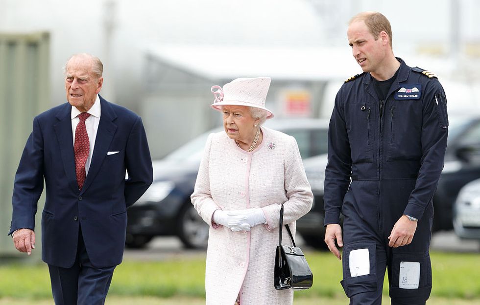 Prince William shows Prince Philip and the Queen around new East Anglian Air Ambulance base at Cambridge Airport, July 2016