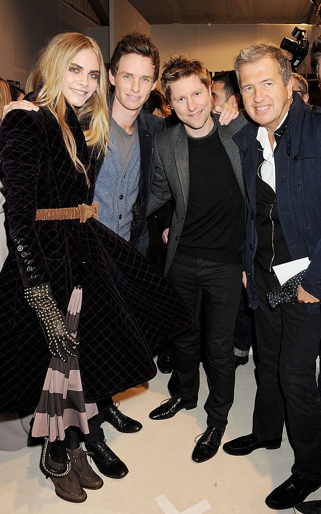 Cara Delevingne, Eddie Redmayne, Christopher Bailey and Mario Testino at the Burberry show in 2012