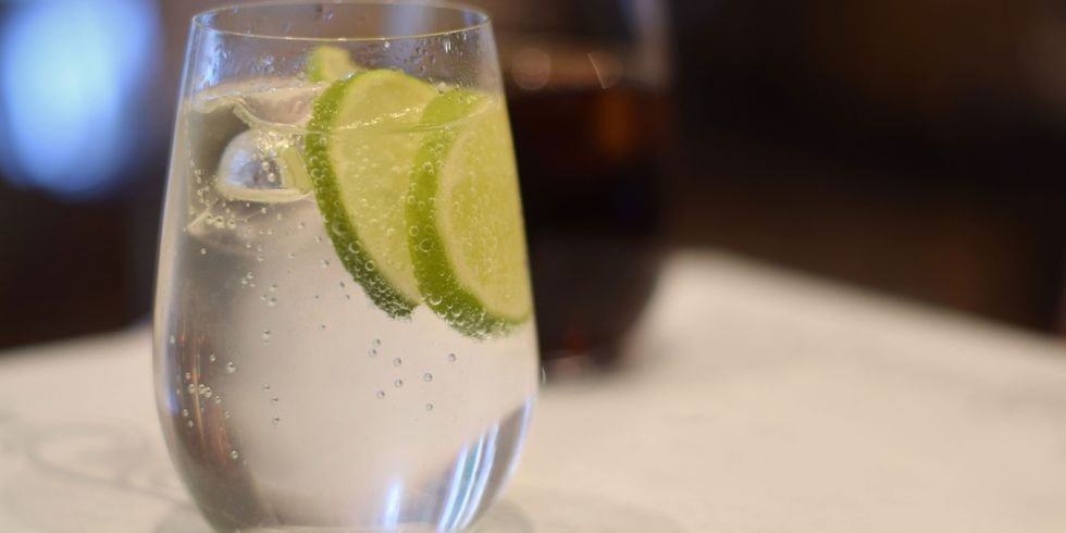 Close up of a glass of sparkling water with lime