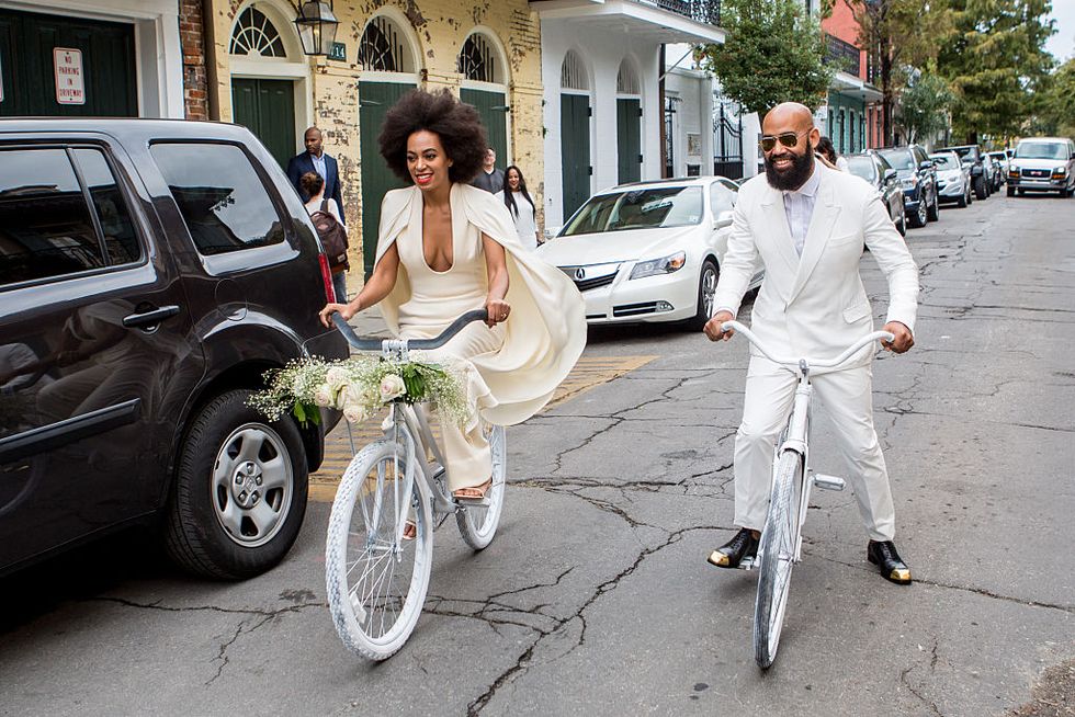 Solange and Alan Ferguson riding bikes on their wedding day in New Orleans