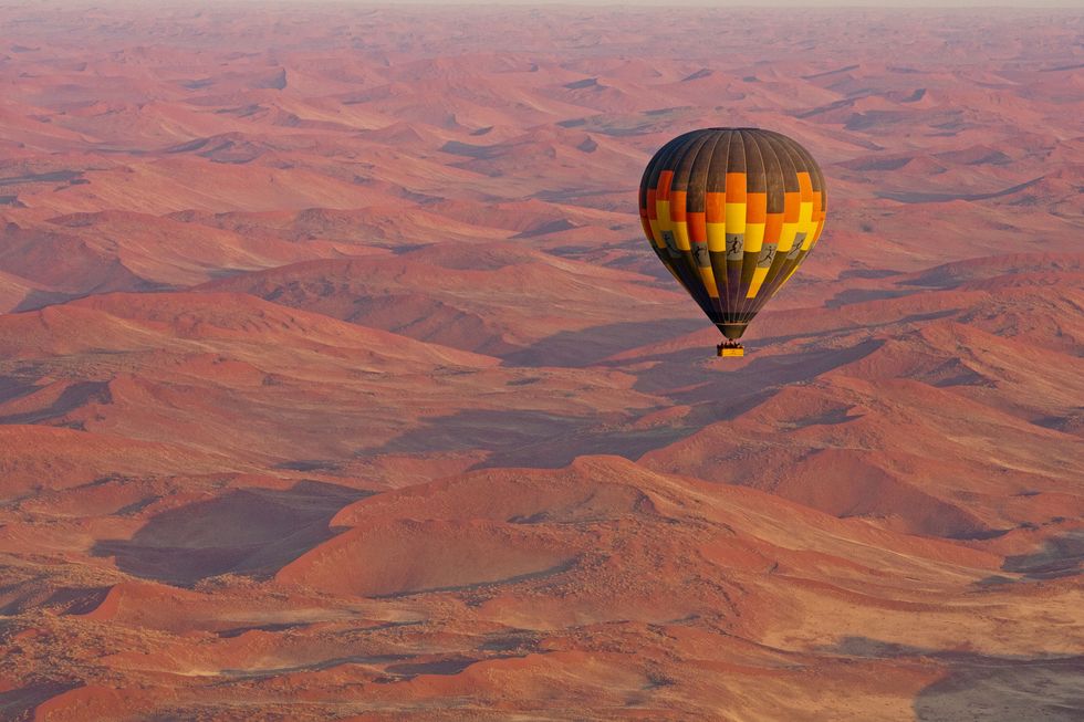 Hot air ballooning, Hot air balloon, Sky, Air sports, Morning, Geology, Landscape, Atmosphere, Vehicle, Formation, 