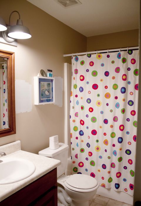 A cartoonish shower curtain and a child-sized toilet made this bland bathroom inappropriate for the adult members of <a target="_blank" href="http://www.hometalk.com/4154434/guest-friendly-nautical-style-small-bath-makeover">blogger Southern Revivals</a>'s family.