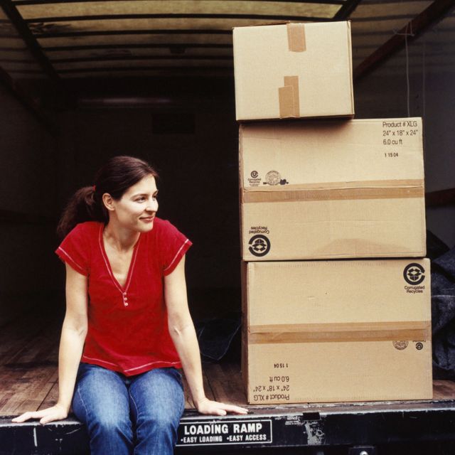 Woman in a moving truck with boxes