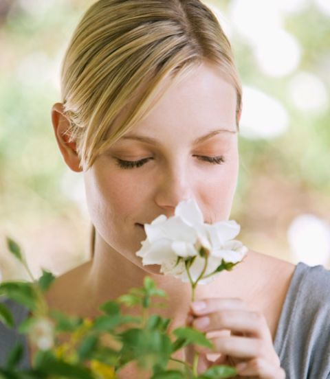 woman smelling flower