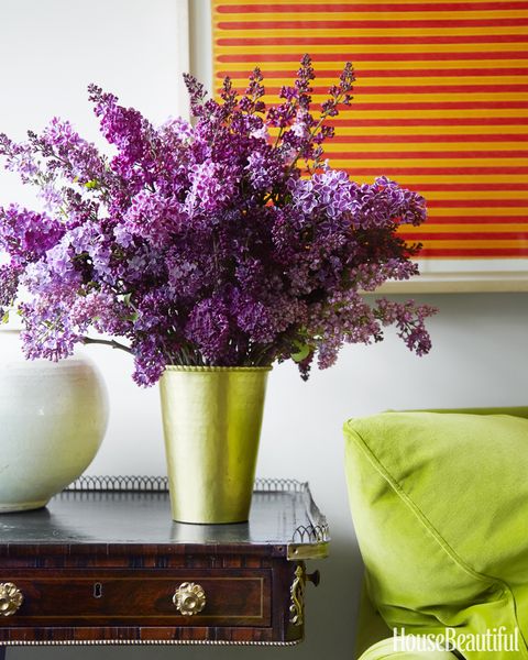 Lilacs from the garden add another burst of color to the room.
