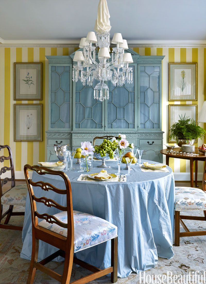 Redd brought in a breakfront to anchor the space and had it painted in one of his mother's favorite colors, an 18th century-inspired chalky green. A table skirt made from taffeta is a soft contrast to the mahogany ladder-back chairs.