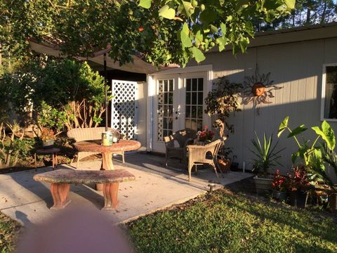 Plant, House, Real estate, Building, Garden, Outdoor table, Outdoor furniture, Home, Fixture, Shade, 