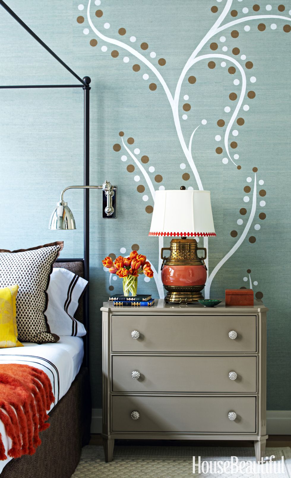 <p>The walls in the master bedroom were covered in Phillip Jeffries's Manila Hemp and then stenciled with abstract trees, designed by Ridder and executed by the Chuck Hettinger Studio, Inc. Bedside table by Chelsea Editions. Reading light by Ann-Morris, Inc.</p>