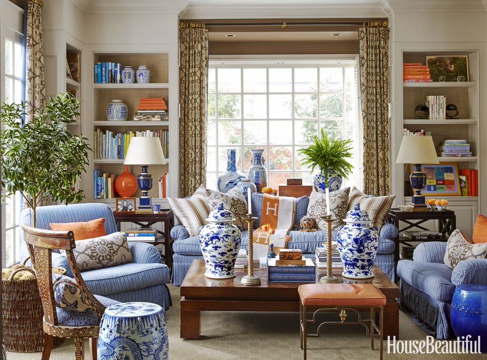 the study's sofa and armchairs are upholstered in a jasper stripe throw, hermès annika lamps, mary mcdonald for robert abbey inlaid chair, singh imports garden stools, jf chen left and mecox right walls in benjamin moore's monterey white