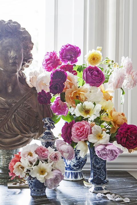 console table with a display of a bust and flowers