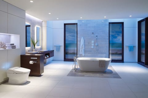 <p>Bold dark wood contrasts beautifully against the cool blue lighting and sleek fixtures in this minimalist, quiet space. A freestanding tub and TOTO toilet add to the elegance. </p>