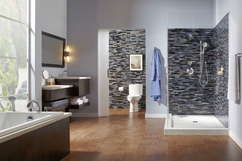 <p>Wooden flooring isn't incredibly common in bathrooms, though honestly, we're not sure why. With oversized windows, <a href="http://www.totousa.com/" target="_blank">TOTO</a> fixtures and stunning, multi-dimensional tiles, we'll never tire of this look.</p>