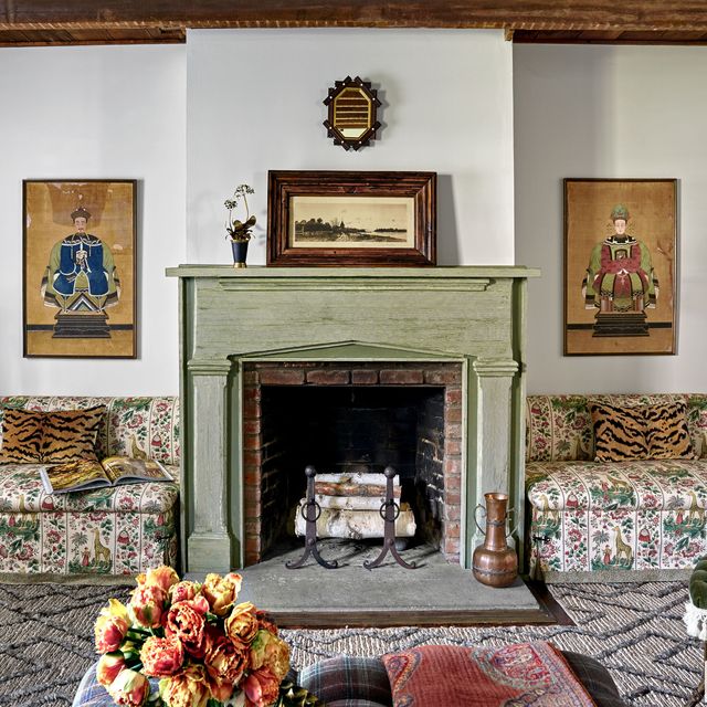 <p>The living room's banquettes, in Pierre Frey's Ismaelia, flank a mantel with a combed faux finish by Dean Barger. "We don't do animal prints often," Maxwell Foster says of the pillows. "But Scalamandré's Tigre velvet is so luxe and warm, it worked here." The 1876 chair is by George Jacob Hunzinger. A Bunny Williams for Dash &amp; Albert rug was cut and trimmed to fit around the hearth.<span class="redactor-invisible-space" data-verified="redactor" data-redactor-tag="span" data-redactor-class="redactor-invisible-space"></span></p>