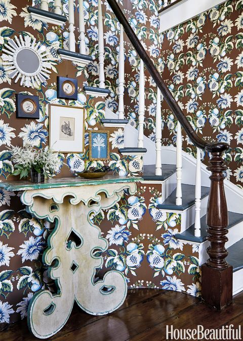 The stair hall is sheathed in an Oscar de la Renta wallpaper from Lee Jofa; Maxwell Foster and her partner Suysel dePedro Cunningham found the dramatic Italian table at Nickey Kehoe in Los Angeles.