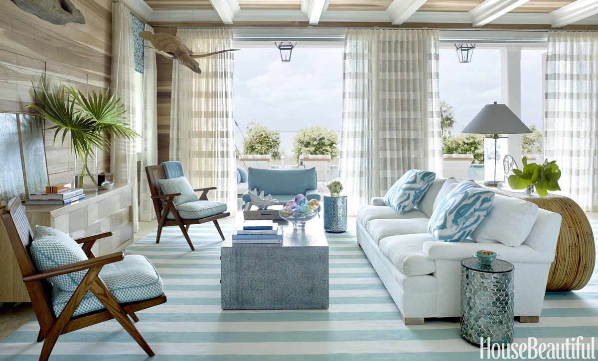 The living room's raw-poplar walls give the feel of "a fisherman's shack," Watson says. A sofa by Lee Industries is upholstered in Manuel Canovas's Cruz, with pillows in an Amanda Nisbet silk. The Hollywood at Home armchairs have cushions in a fabric from Jerry Pair.