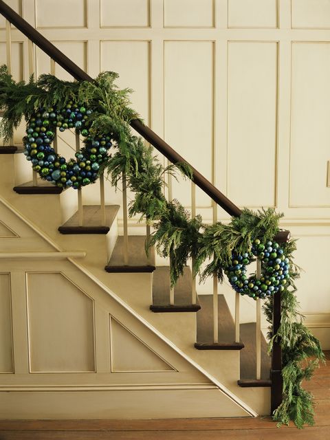 Stairs, Christmas decoration, Holiday, Christmas, Handrail, Ornament, Molding, Pine family, Wood stain, Evergreen, 