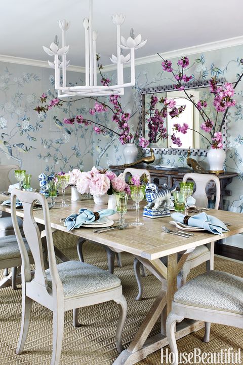 De Gournay's hand-painted chinoiserie tea paper on the walls gives the dining room its dazzle, while Dan Mosheim's custom cerused-oak farm table acts as a gracious supporting player. The client bought the mirror at an antiques show. "It's perfect," Watt says. "It has a great shape, but it's not a big gilt thing taking attention away from the paper." The antique Swedish chairs are covered in a Peter Fasano linen.
