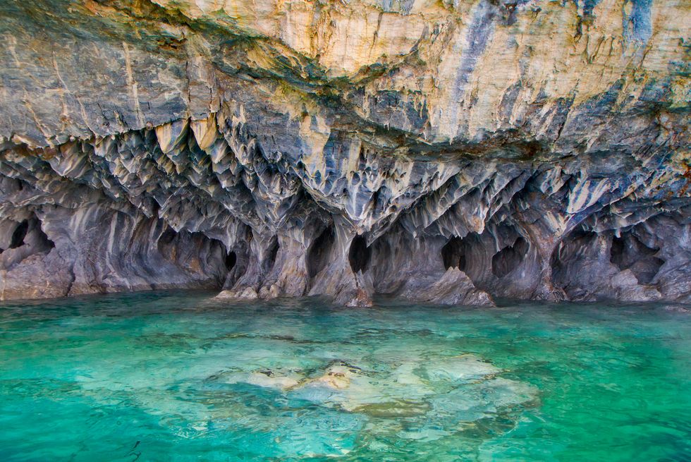 Body of water, Coastal and oceanic landforms, Liquid, Sea cave, Rock, Fluid, Formation, Turquoise, Geology, Teal, 