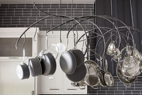 <p>When a space has tall ceilings, you need a little drama up high, too.&nbsp;Partnering with an artisan, de la Cruz&nbsp;designed the custom rack for&nbsp;maximum convenience — each pot is hung with&nbsp;its&nbsp;lid, so no need to dig through cabinets for its mates. Polished nickel globe bulbs&nbsp;by&nbsp;<a href="http://www.troy-lighting.com/" target="_blank">Troy Lighting</a>&nbsp;intermingle&nbsp;for additional lighting, a must over an active prep space.<span class="redactor-invisible-space" data-verified="redactor" data-redactor-tag="span" data-redactor-class="redactor-invisible-space"></span></p>