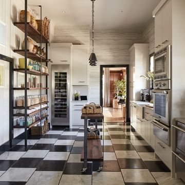 <p>The color scheme that runs throughout, beginning with the Versailles-inspired black and white <a href="http://www.allnaturalstoneinc.com/prepress_portfolio/haussmann/" target="_blank">Hausmann</a> tile, nods to the San Francisco home's history:&nbsp;"The intent was for a classic black and white kitchen, like sea salt and black pepper.&nbsp;I chose Cornforth White and Off Black from <a href="http://us.farrow-ball.com/" target="_blank">Farrow and Ball</a>&nbsp;for the walls,&nbsp;which gives the timeless combination a slight patina that fit the&nbsp;100-year-old&nbsp;house," says de La Cruz.<span class="redactor-invisible-space" data-verified="redactor" data-redactor-tag="span" data-redactor-class="redactor-invisible-space" style="background-color: initial;" rel="background-color: initial;" data-redactor-style="background-color: initial;">&nbsp;Look closely and you'll see the tiles are set off-center, which makes&nbsp;the room&nbsp;feel&nbsp;more casual.</span></p>
