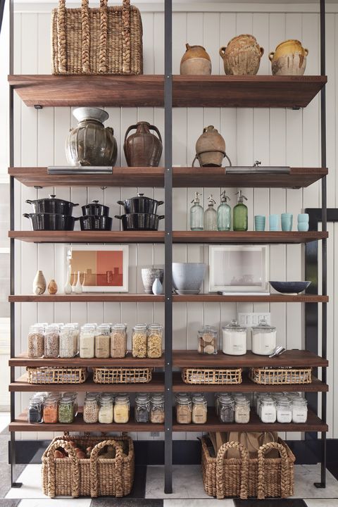 <p>"Every square inch of the kitchen's T-shaped footprint had to be considered and utilized," says de la Cruz. Shelving by <a href="https://www.glumber.com/" target="_blank">Grothouse</a>&nbsp;serves&nbsp;as a transparent&nbsp;pantry while the glass&nbsp;<a href="https://blisshaus.com/" target="_blank">Blisshaus</a>&nbsp;jars allow&nbsp;families to&nbsp;see&nbsp;what they have, use it&nbsp;and buy less, reducing waste while&nbsp;resulting in savings, according to the company.&nbsp;<span class="redactor-invisible-space" data-verified="redactor" data-redactor-tag="span" data-redactor-class="redactor-invisible-space"></span></p>