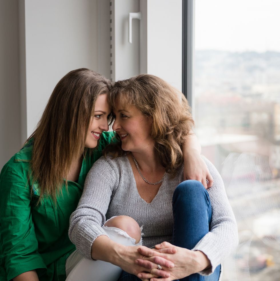 smiling teen daughter and her mother looking at each other