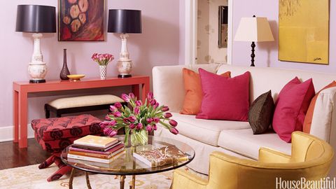 pink living room with colorful pillows