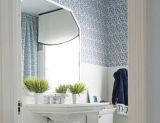 blue and white bathroom with fabric on walls