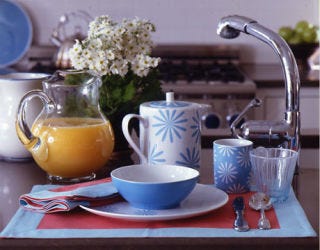 Blue and white dishes on a kitchen island as featured in the June 2007 issue.
