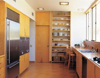 open airy kitchen with wood and stainless steel cabinets and appliances