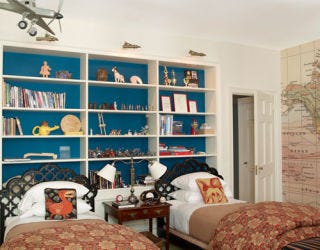 boy bedroom with two twin beds and inset shelves behind